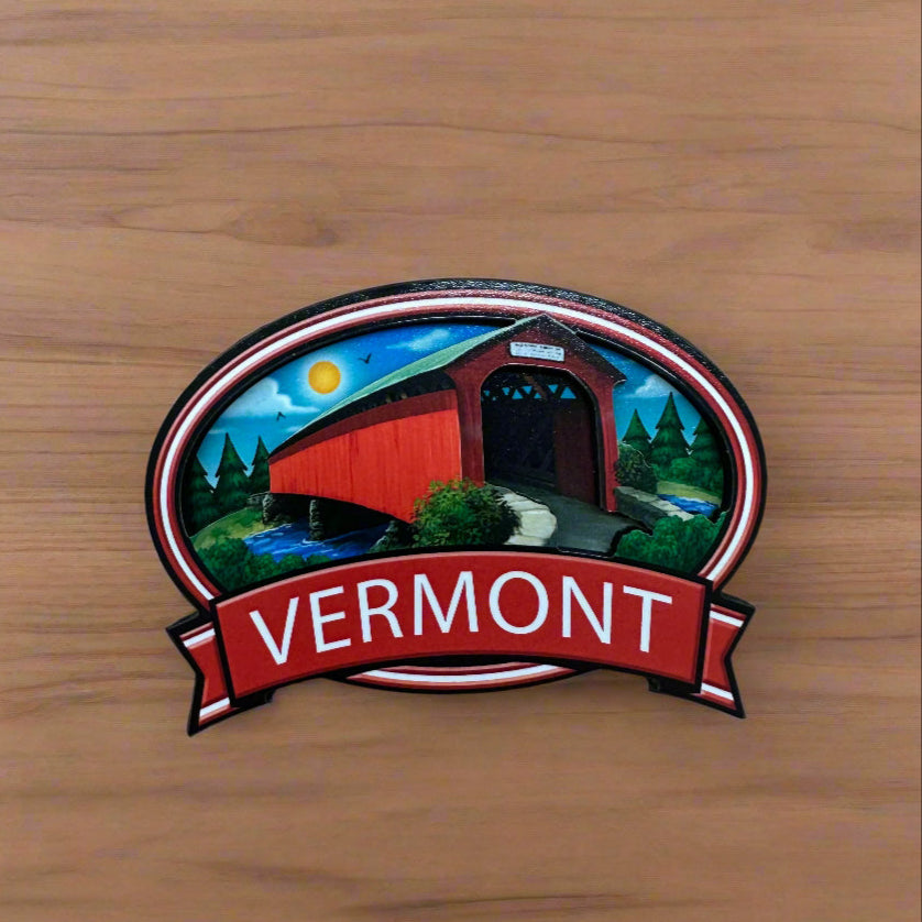 Sticker with 'VERMONT' text on a wooden surface